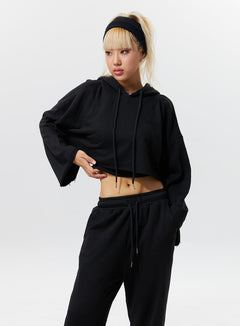 LEWKIN Sweatsuits Sets 3 Piece Outfit BF317 in black, front 3/4 view on model standing with hand on hip, crop hoodie with drawstring and wide-sleeve paired with matching wide-leg sweatpants.
