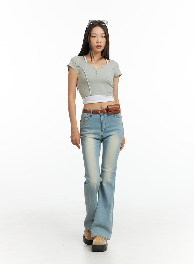 LEWKIN Light Washed Slim Fit Bootcut Jeans IL409 in light blue, full-body front view on model walking, slim fit with washed fading, paired with crop top and brown belt bag.