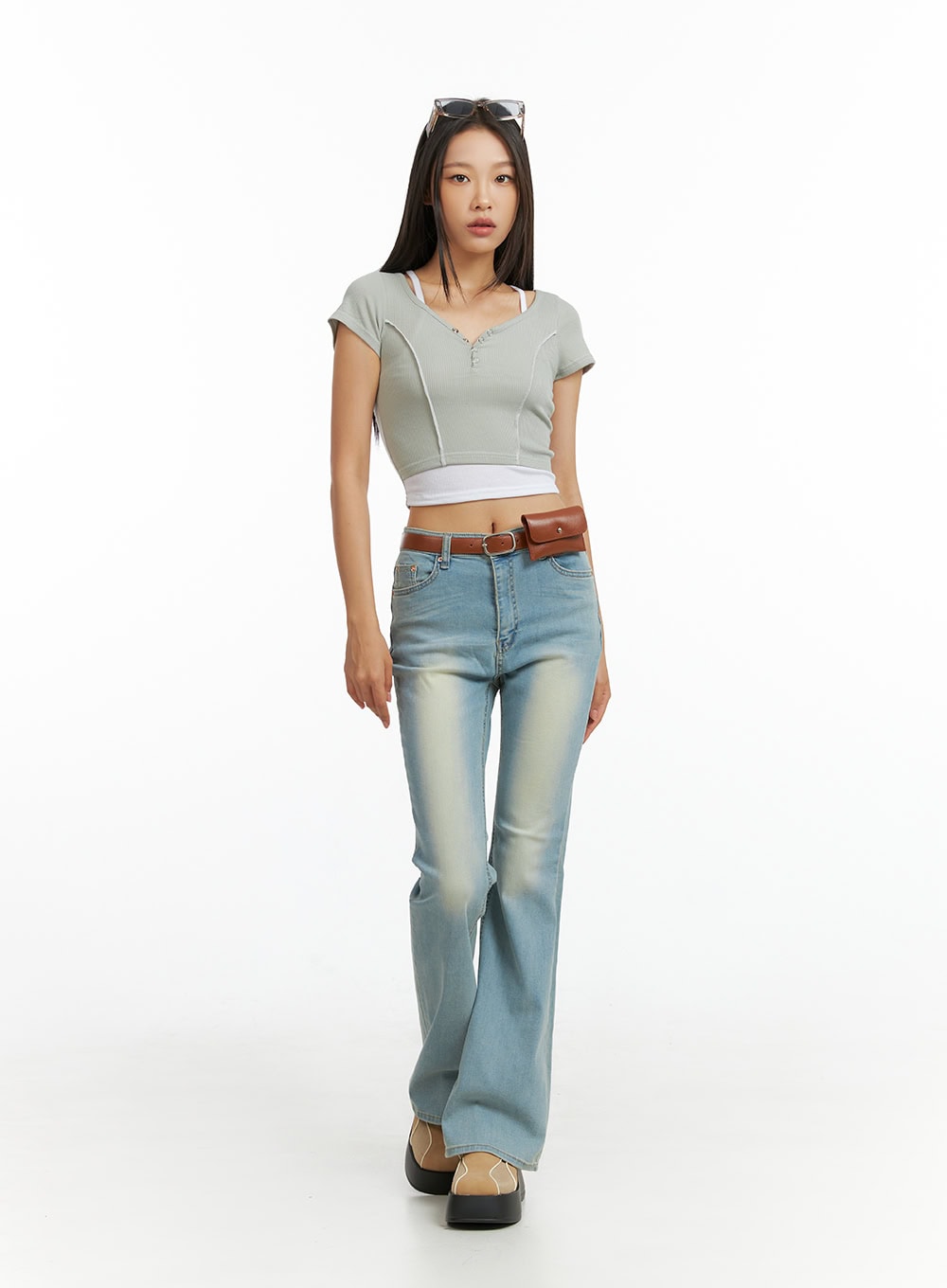LEWKIN Light Washed Slim Fit Bootcut Jeans IL409 in light blue, full-body front view on model walking, slim fit with washed fading, paired with crop top and brown belt bag.