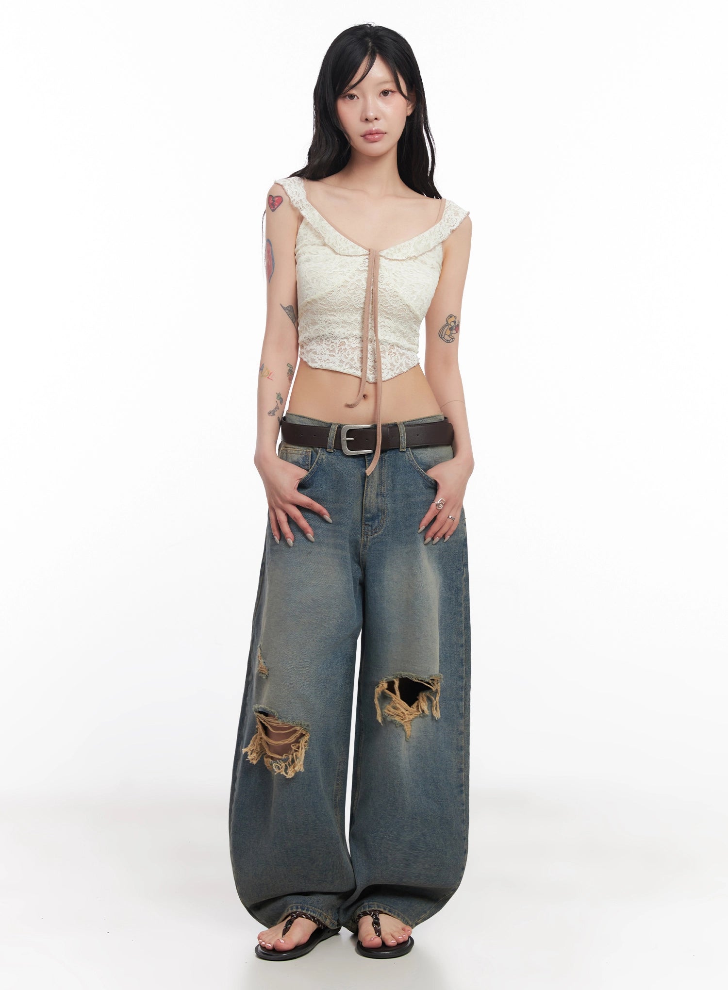LEWKIN Jeemin Vintage Distressed Wide-Leg Denim Jeans IC503 in washed blue, full-length front view on model, heavy destroyed knee rips, baggy silhouette, styled with lace crop top and belt.