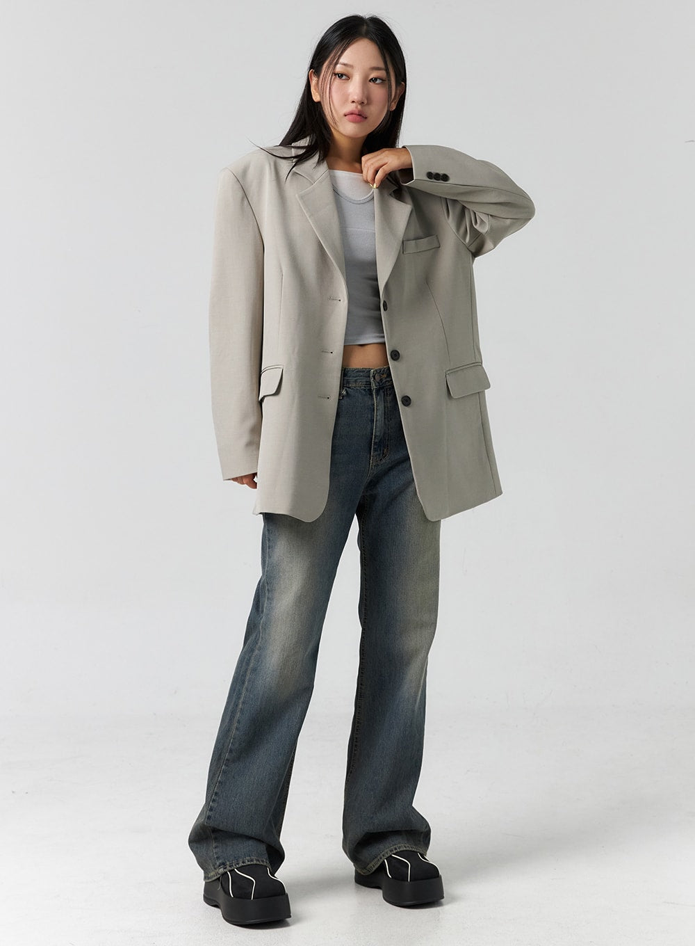 LEWKIN Vintage Wash Bootcut Jeans CS305 in blue, full-body front on model, vintage-washed denim with bootcut hem, styled with oversized blazer and white crop top.
