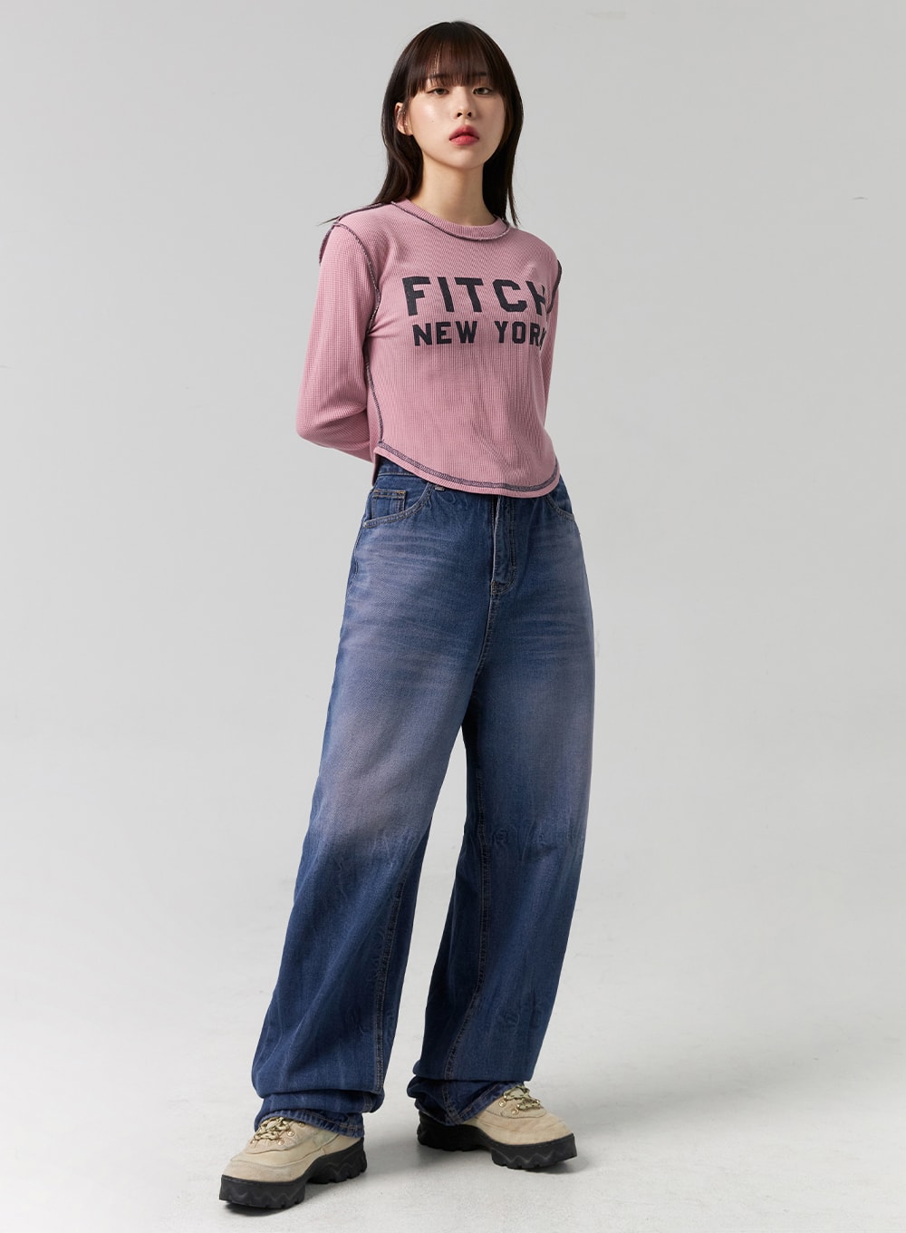 LEWKIN Wide Leg Cotton Jeans CG331 in blue, full front view on model, washed denim wide-fit with high waist, paired with pink graphic crop top and chunky sneakers.