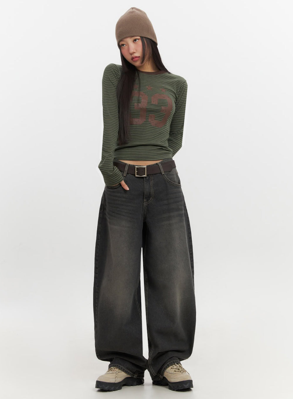 LEWKIN Skyla Washed Wide-Leg Baggy Jeans IF511 in washed black, full-body front view on model with beanie, ultra-wide balloon leg silhouette, paired with green striped crop top and belt.