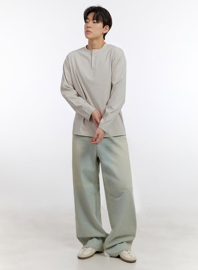 LEWKIN Men's Washed Wide-Leg Jeans IF528 in light sage green, full-length front view on model with slight turn, relaxed wide leg pooling at hem, paired with beige henley top and white sneakers.