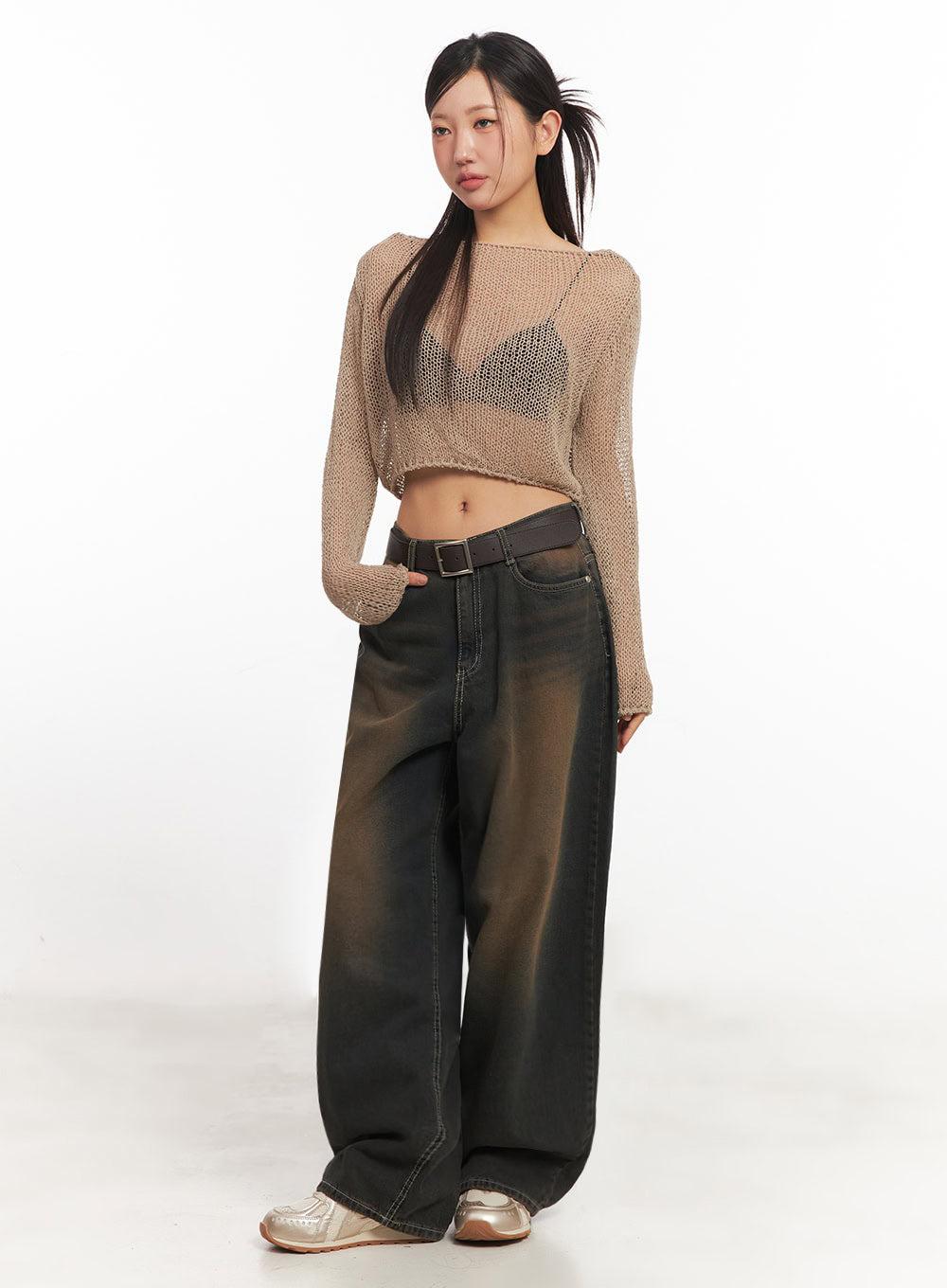 LEWKIN Bethany Vintage Washed Baggy Jeans IA524 in dark brown washed denim, 3/4 front view on model, wide-fit with contrast stitching, belted, paired with beige mesh crop knit and silver sneakers.