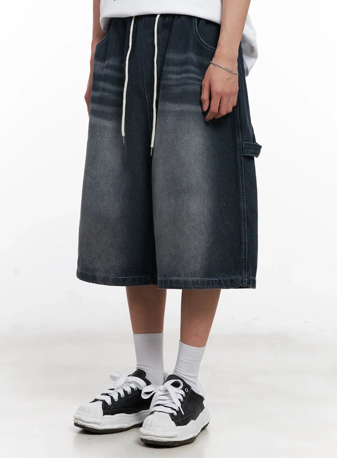 LEWKIN Men's Washed Jorts IL504 in dark washed grey, front close-up on model, wide-leg knee-length denim with elastic drawstring waist, paired with white sneakers.