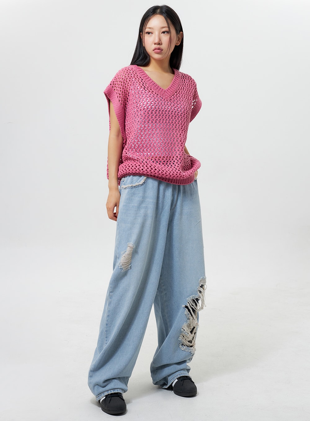 LEWKIN Oversized Ripped Jeans CY324 in light blue, full-body front view on model, wide-leg cotton denim with heavy distressing, banded waist, styled with pink crochet vest.