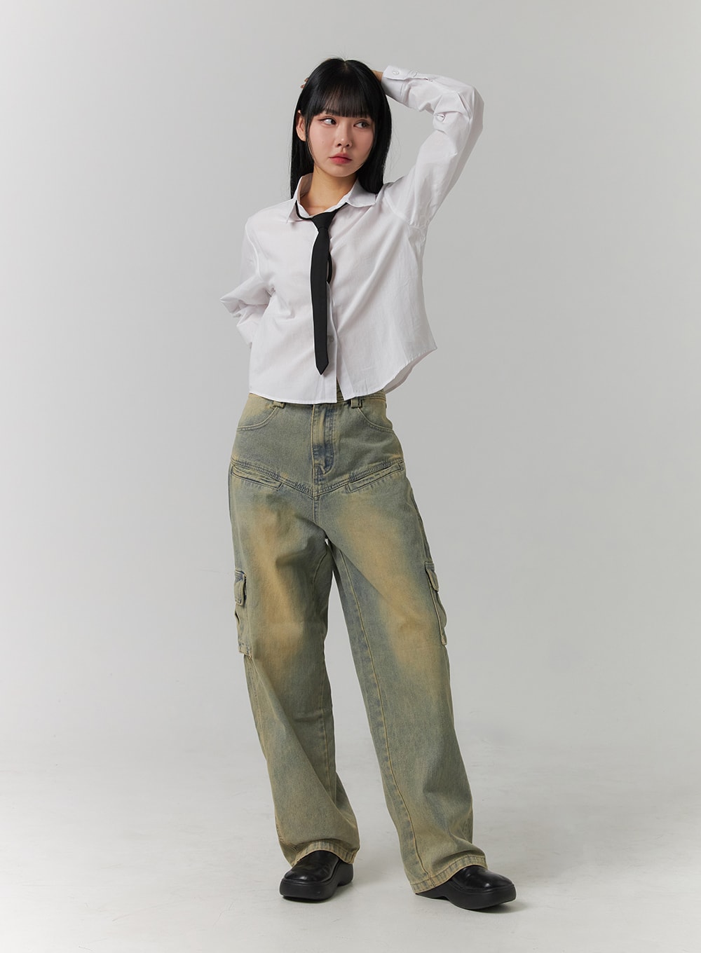 LEWKIN Cargo Denim Straight Leg Jeans CJ422 in blue, full-body front view on model, hand raised to head, wide-fit washed cotton denim with cargo pockets, styled with white cropped shirt and black tie.