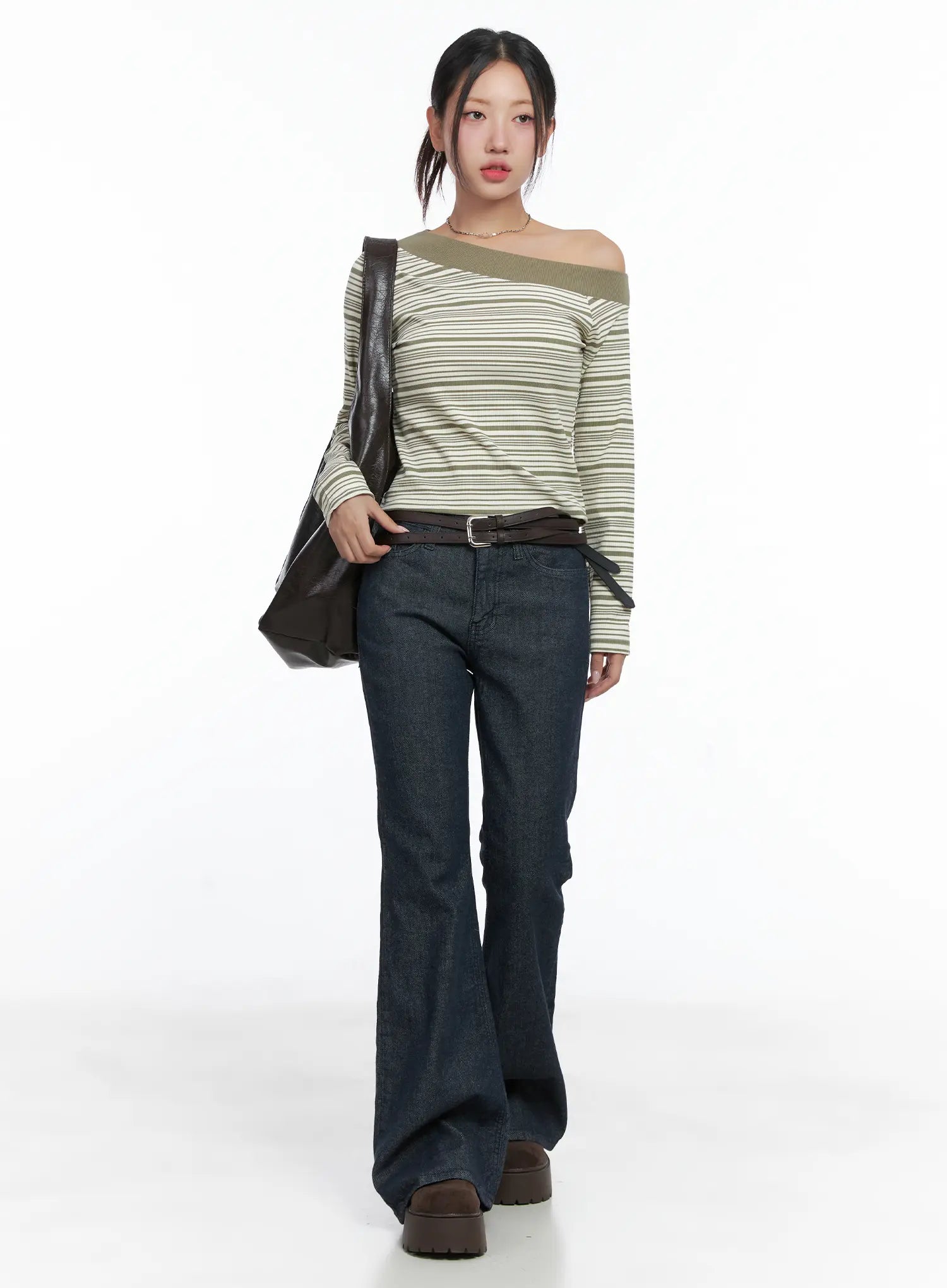 LEWKIN Kinley Flare Jeans CS502 in dark indigo, full-length front view on model walking, long flare leg, cotton-spandex denim, styled with striped off-shoulder top and brown bag.