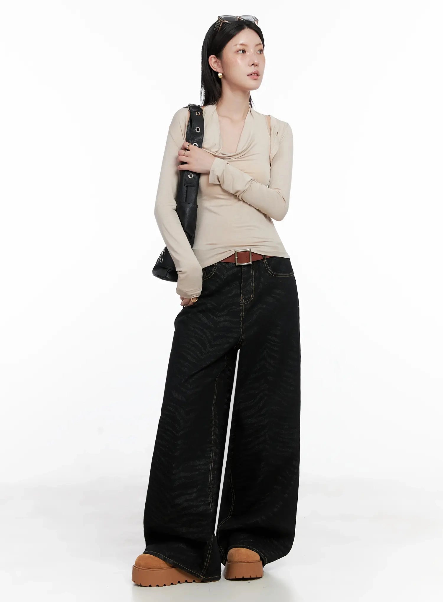 LEWKIN Freyja Animal Print Wide Leg Jeans IS508 in black, three-quarter front view on model, zebra-jacquard cotton denim, wide leg, styled with beige top, brown belt, and platform shoes.