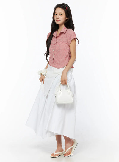 LEWKIN Basic Ribbon Maxi Skirt CU522 in white, 3/4 side full-length shot on model, cotton A-line maxi silhouette with ribbon tie waist, paired with pink textured shirt and white mini bag.