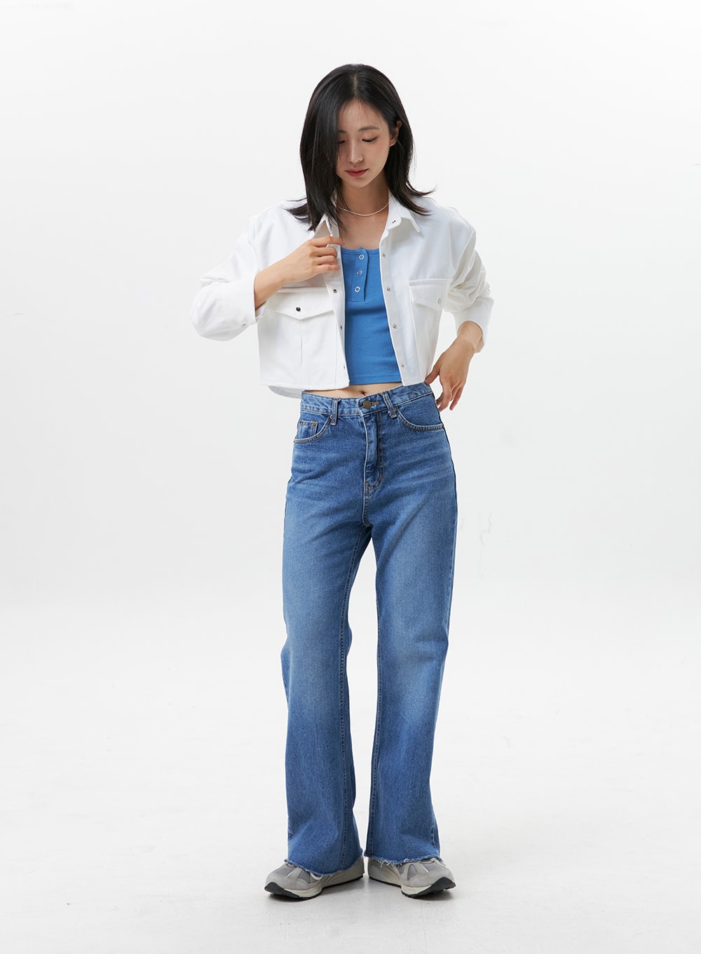 LEWKIN Straight-Leg Jeans OG318 in medium blue, full-length front view on model, high-rise cotton denim with slight flare, raw hem, paired with white cropped shirt and blue tank.