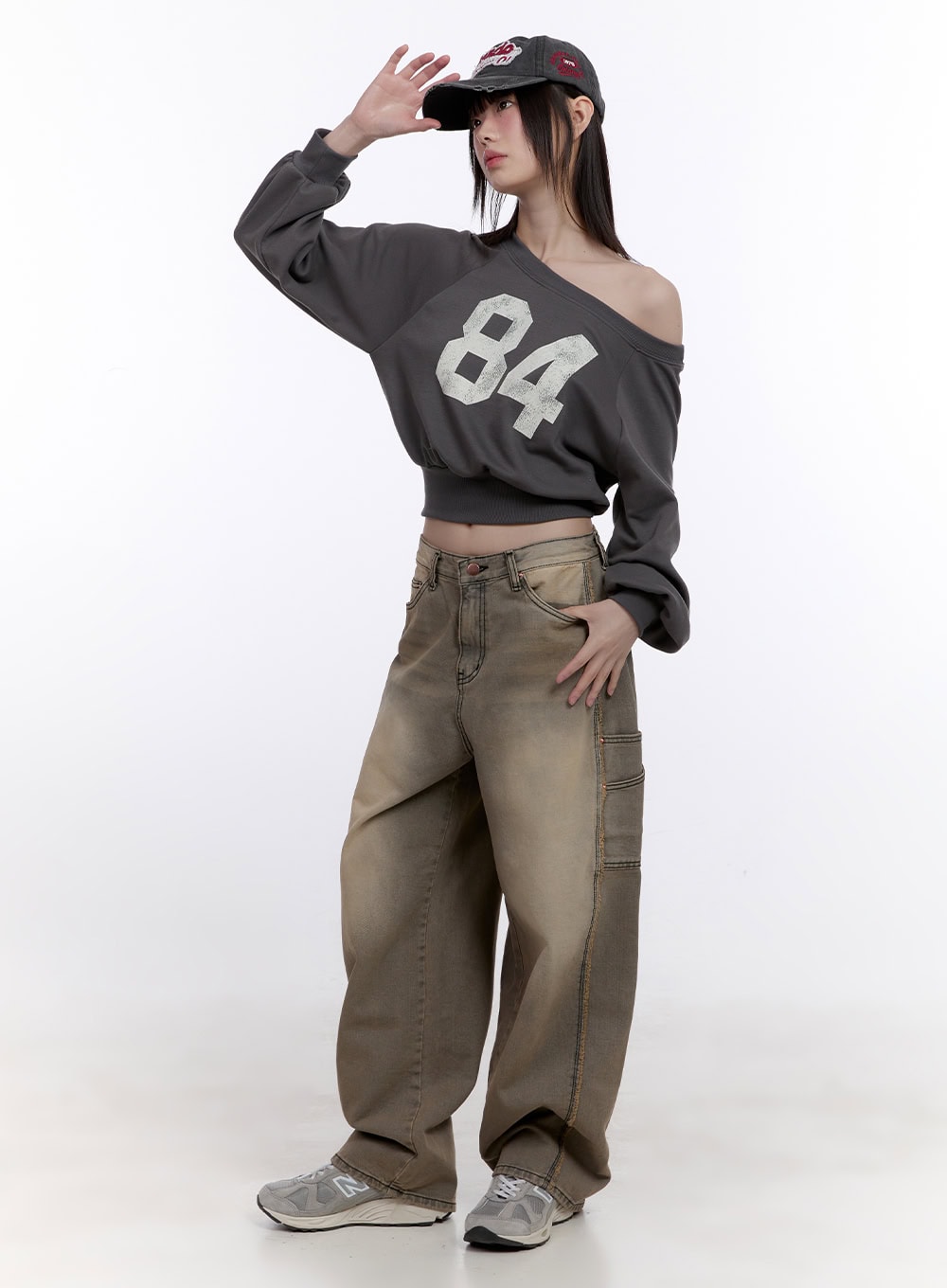 LEWKIN Sara Stitched Pocket Baggy Jeans CF512 in Beige, full-length front view on model, wide-fit washed denim with stitched pockets, styled with grey crop sweatshirt and cap.