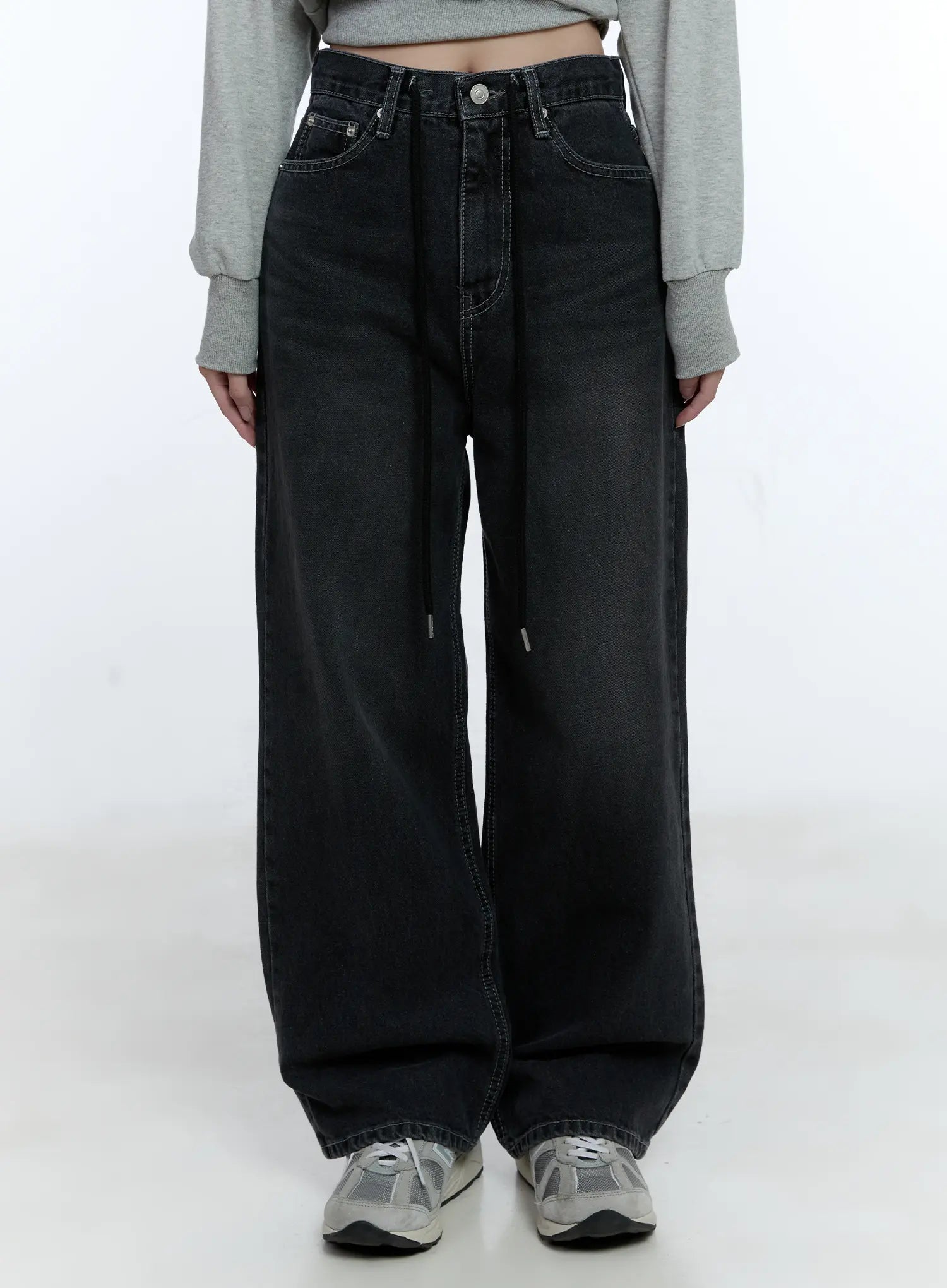 LEWKIN Lucinda High-Rise Wide Leg Jeans CG512 in black, front cropped view on model, washed denim, high-rise waist with drawstring detail, wide leg silhouette, paired with gray crop sweatshirt and sneakers.
