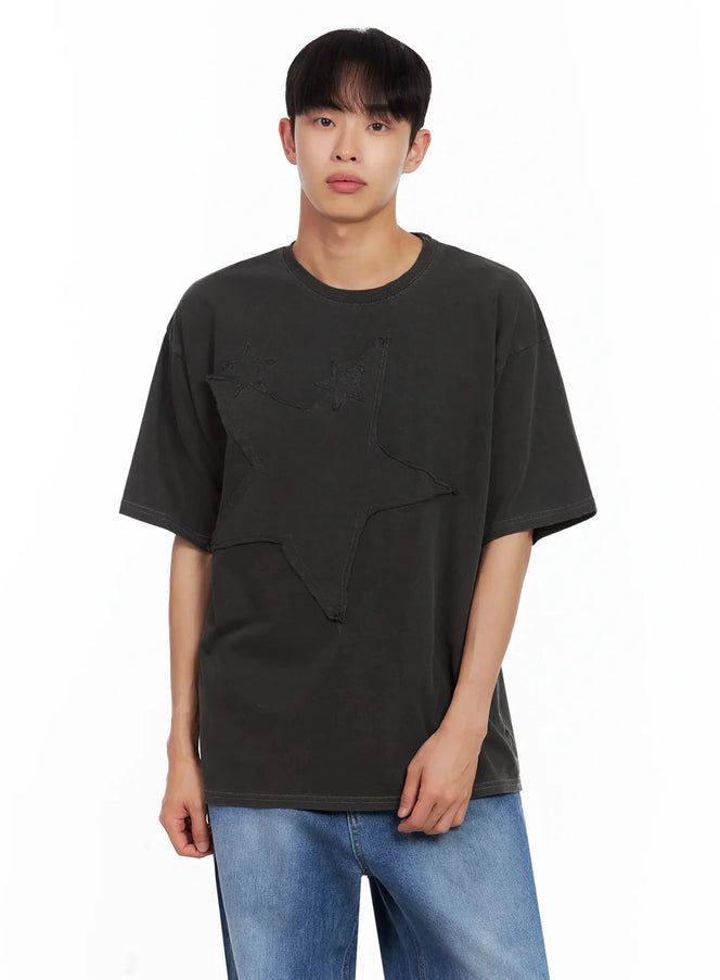 LEWKIN Men's Star Patch T-Shirt IL516 in black, front view on model, oversized fit with tonal layered star patch detail on chest, paired with blue wide-leg jeans.