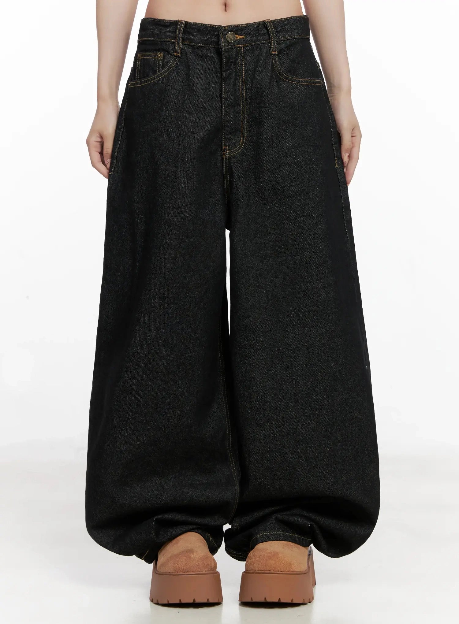 LEWKIN Halo Wide Leg Stitch Detail Jeans IN514 in black, front waist-down shot on model, cotton wide-fit denim with contrast gold topstitching, balloon hem pooling over tan platform shoes.