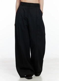 LEWKIN Wide-Leg Cotton Trousers IF520 in black, front cropped view on model, high-waist pintuck cotton wide-leg silhouette, belt loops, full length, styled with black loafers.