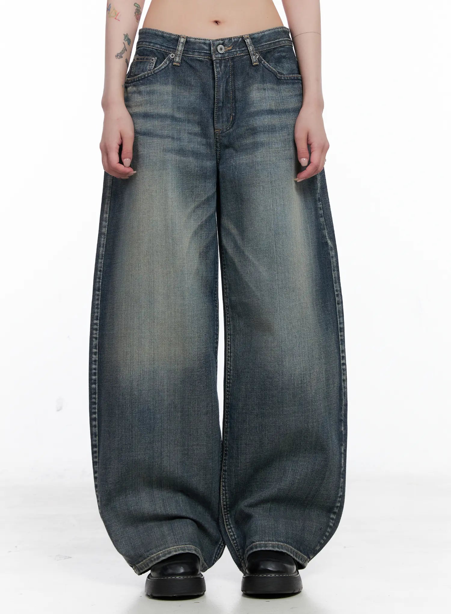 LEWKIN Nellie Baggy Jeans CS526 in blue, front view on model, washed cotton wide-leg with low rise, five-pocket styling, voluminous leg pooling at hem, paired with black loafers.