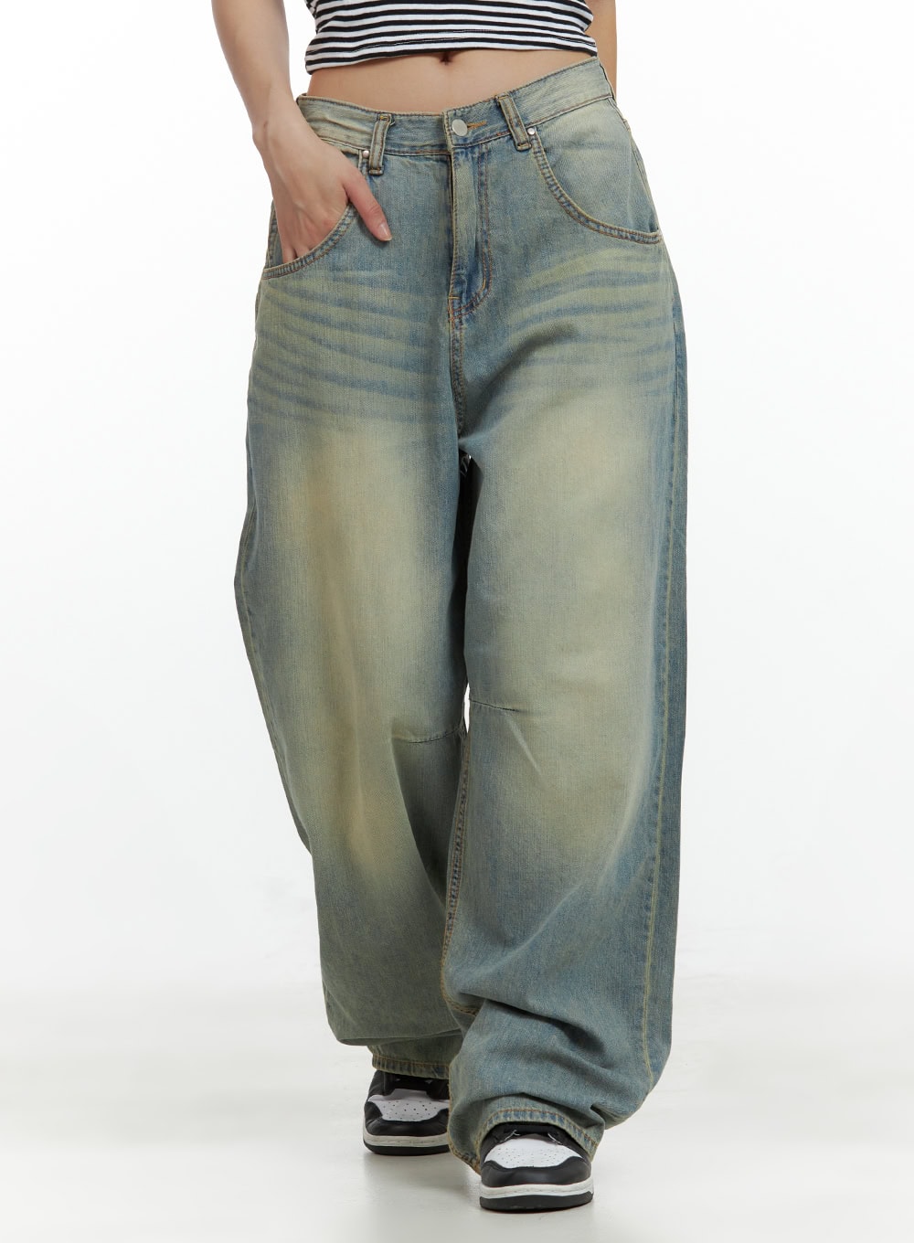 LEWKIN Relaxed Wide-Leg Jeans CU420 in blue, front waist-to-hem crop on model, washed cotton denim with yellow tint fading, hand in pocket, paired with striped crop top and sneakers.