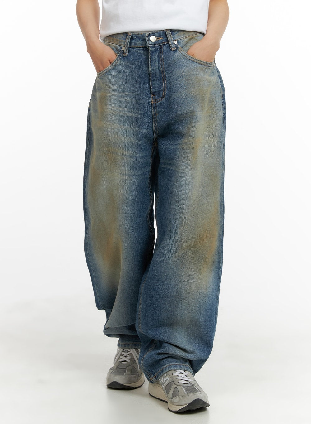 LEWKIN Vintage Washed Baggy Jeans CM426 in blue, front crop shot on model, wide-fit cotton denim with heavy vintage wash and earthy yellow tint, paired with grey sneakers.
