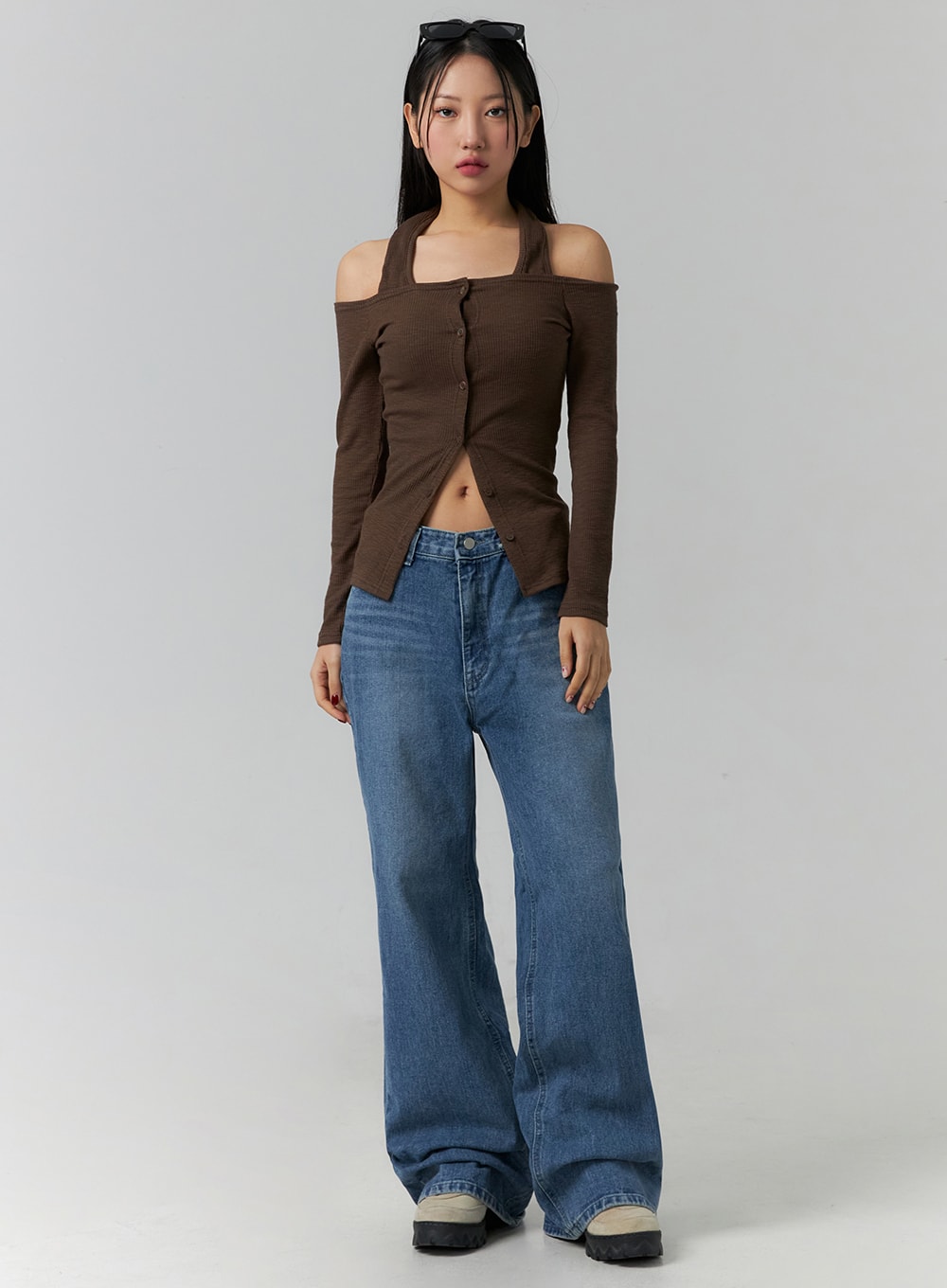 LEWKIN Wide Leg Jeans J12 in blue, full-length front view on model, cotton wide-fit denim with gradation wash, long floor-grazing leg, paired with brown off-shoulder top and chunky sneakers.