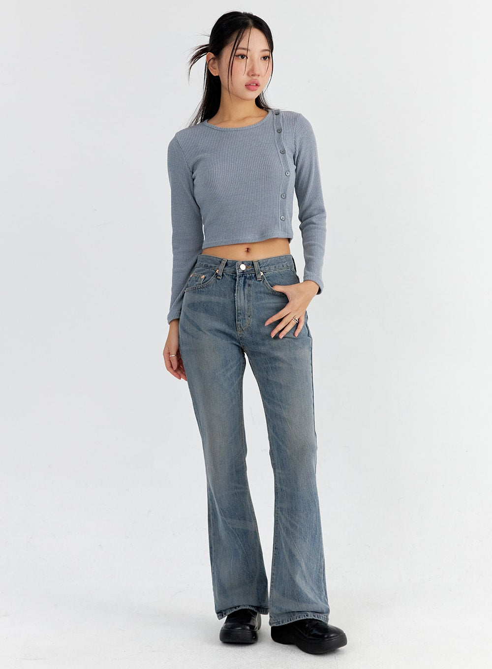 LEWKIN Vintage Washed Bootcut Jeans CO325 in blue, full-body front-angle on model, slim fit washed cotton denim with bootcut flare, paired with grey ribbed crop top and black loafers.