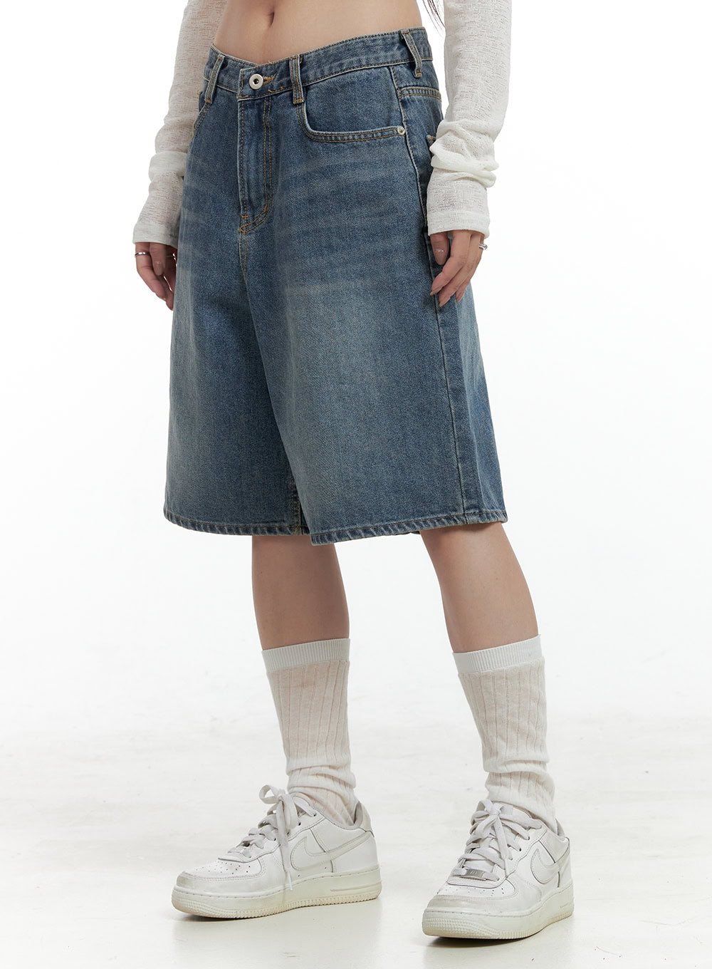 LEWKIN Low Rise Bermuda Jorts CL424 in blue, side close-up on model, wide-leg washed cotton denim, low waist with button fly, paired with white sneakers and crew socks.
