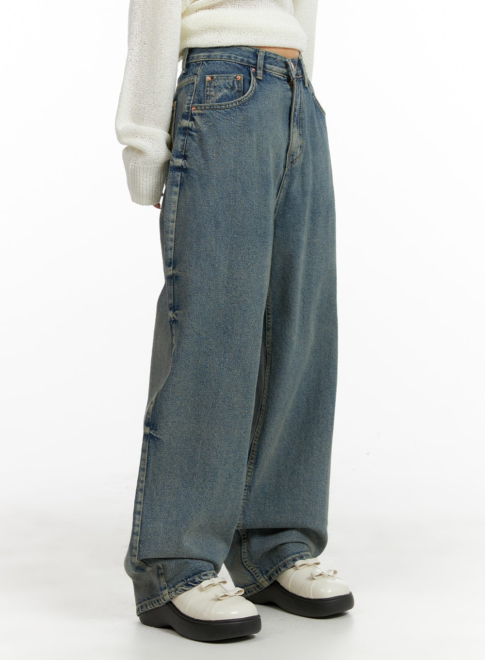 LEWKIN Urban Chic Washed Baggy Jeans CM411 in blue, side view on model, wide-fit washed cotton denim with full-length leg, paired with cream knit sweater and white platform shoes.
