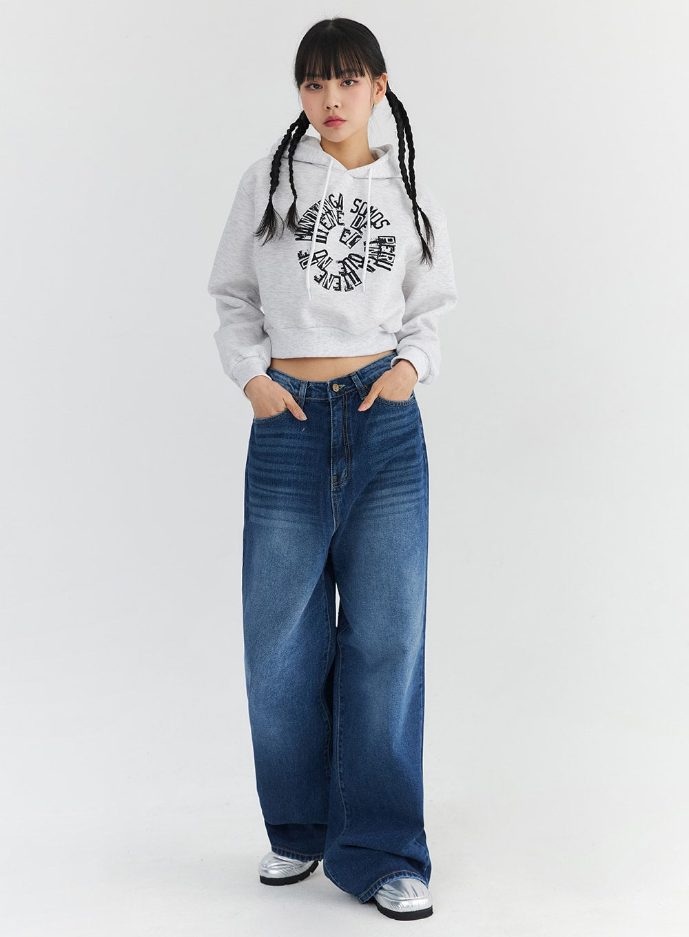 LEWKIN Washed Blue Wide Jeans CN301 in blue, full-length front shot on model in size M, wide-fit washed cotton denim with mid-rise waist, styled with a grey crop hoodie and silver metallic shoes.