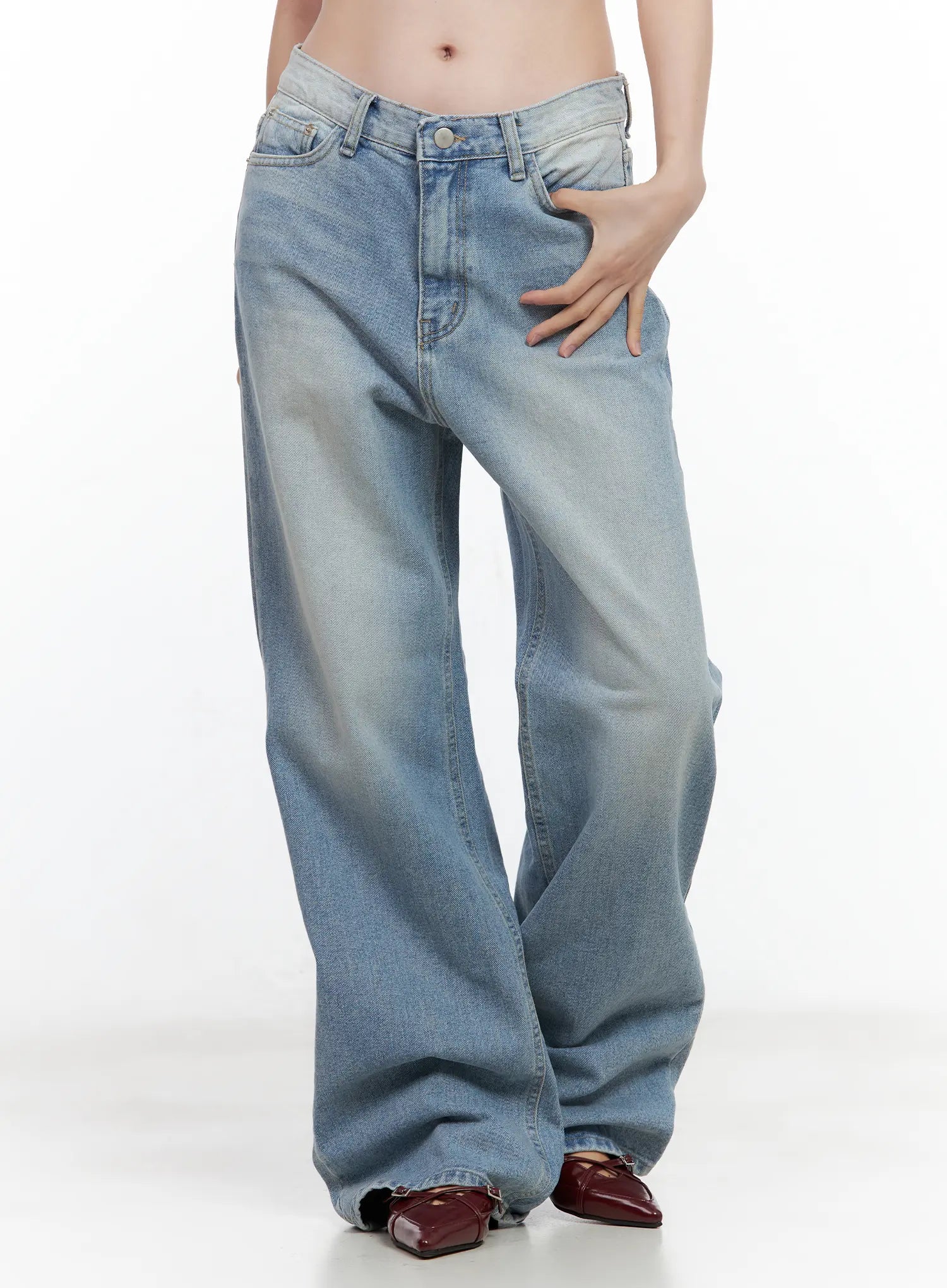 LEWKIN Ina Slouchy Fit Jeans CL502 in blue, front close-up on model, washed cotton denim, low-rise waist with button fly and front pockets, wide slouchy leg, paired with burgundy loafers.