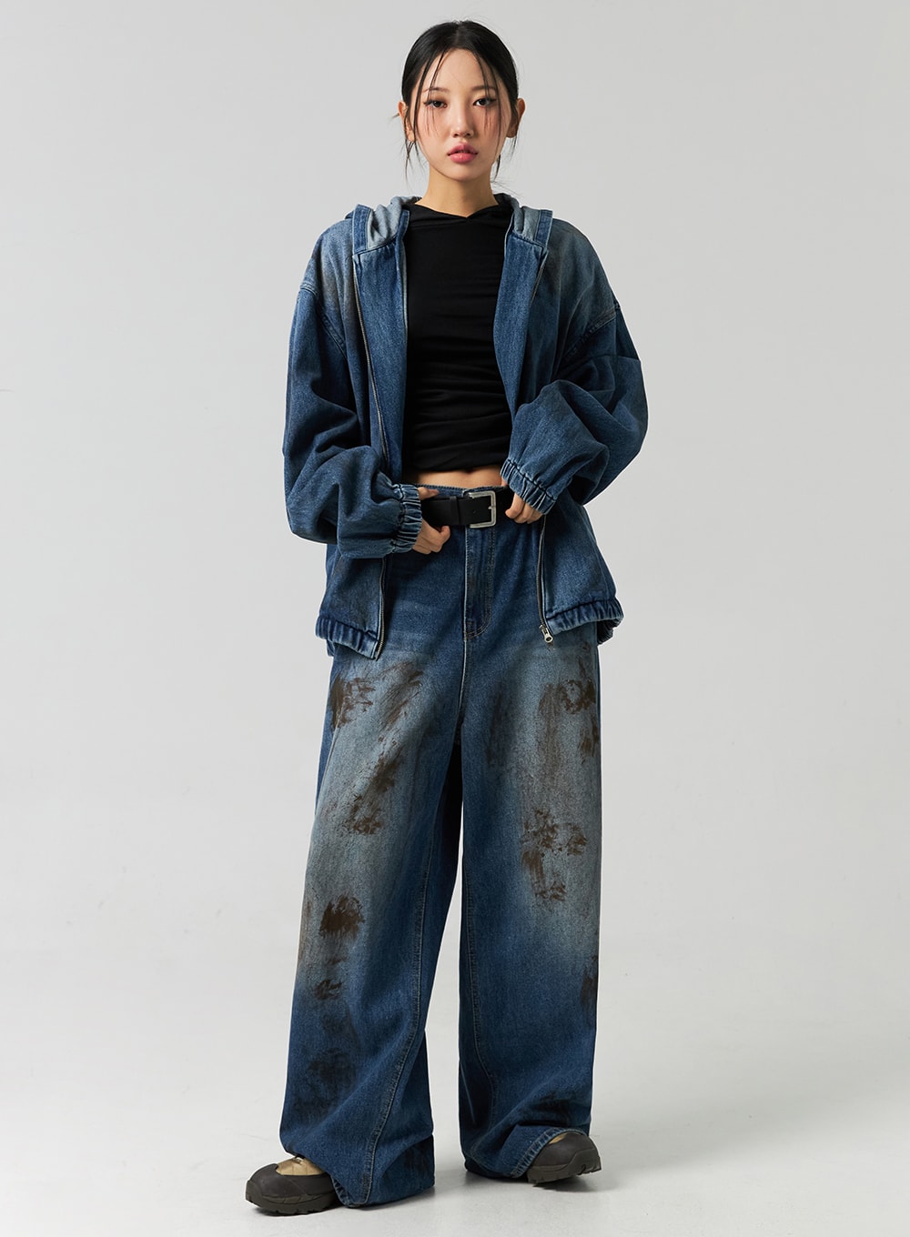 LEWKIN Street-Style Wide Fit Washed Jeans CO323 in Blue, full-body front on model wearing denim hoodie jacket and black belt, wide leg cotton denim with heavy brown washed stain pattern.