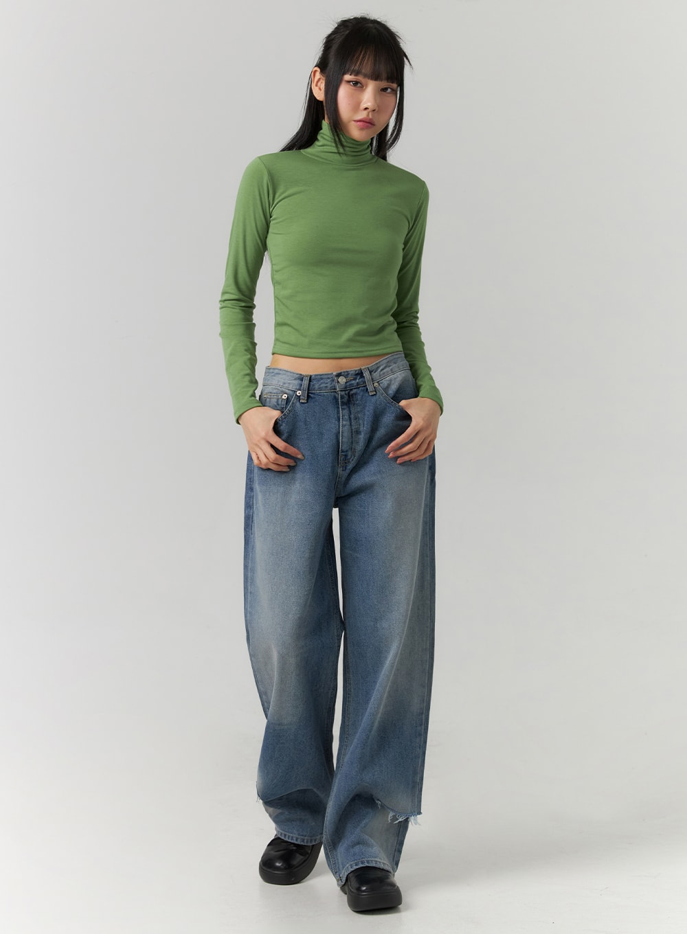 LEWKIN Ripped Straight Leg Jeans CD308 in blue, full-length front view on model, wide-fit washed cotton denim with destroyed hem, styled with a green crop turtleneck and black chunky shoes.