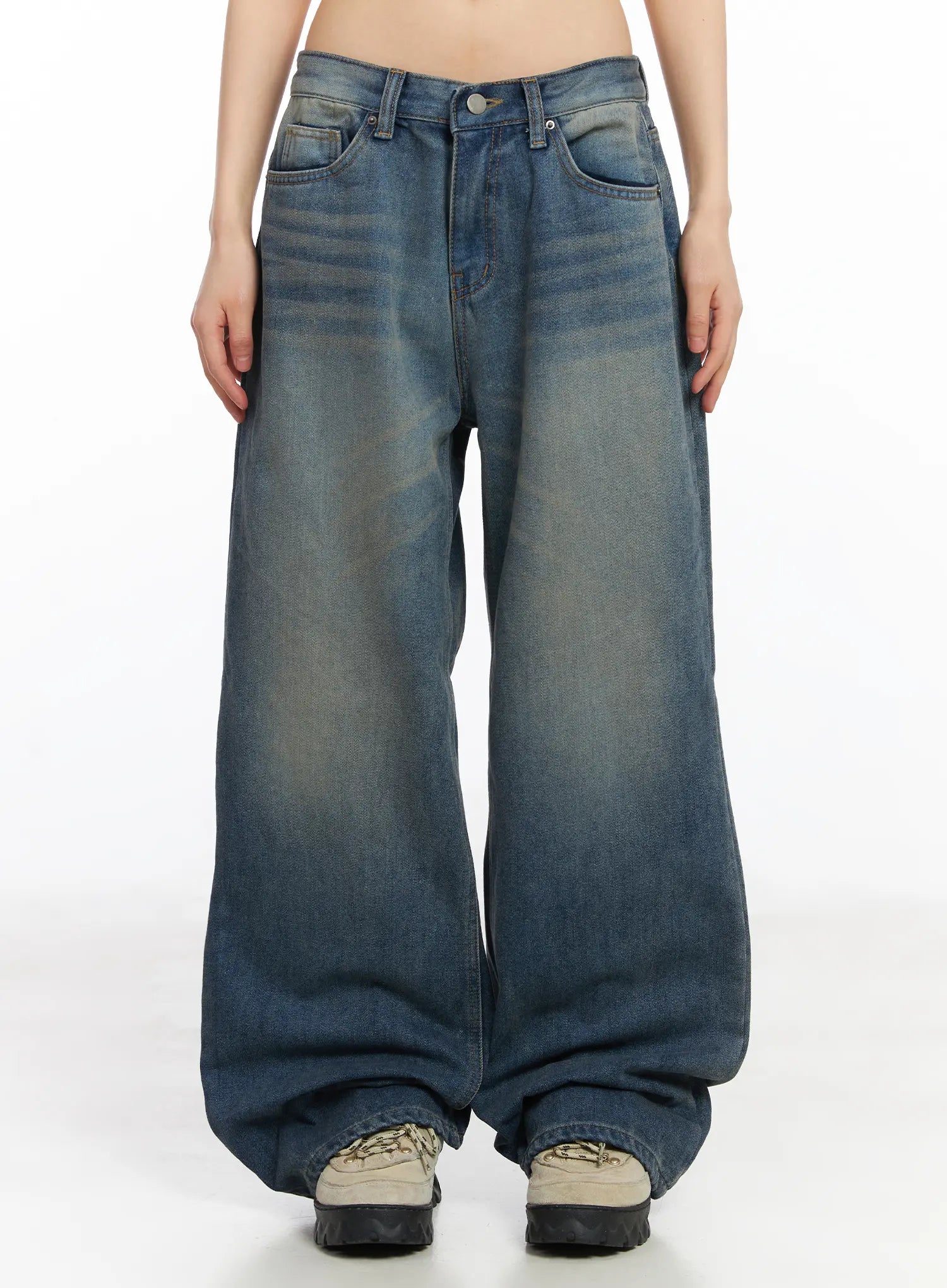 LEWKIN Miriam Wide Leg Jeans CD519 in blue, front view on model, washed cotton wide-fit denim with subtle fading, five-pocket design, pooling at chunky sneakers.