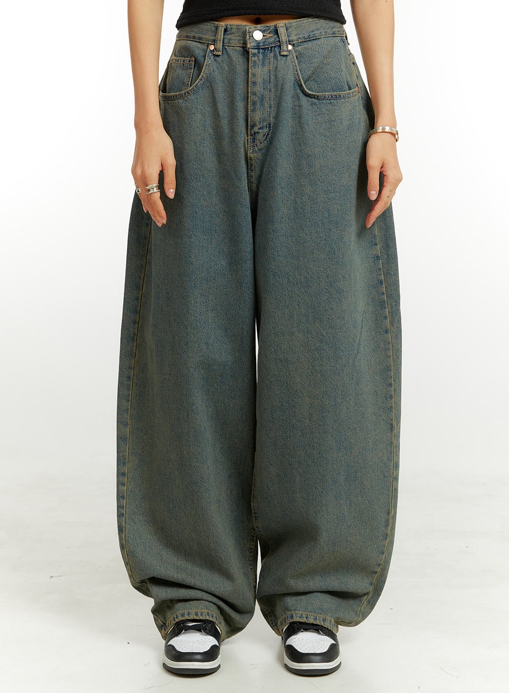 LEWKIN Denim Washed Baggy Jeans CU424 in blue, front close-up on model, ultra-wide washed cotton denim with curved leg silhouette, paired with black crop top and Jordan sneakers.