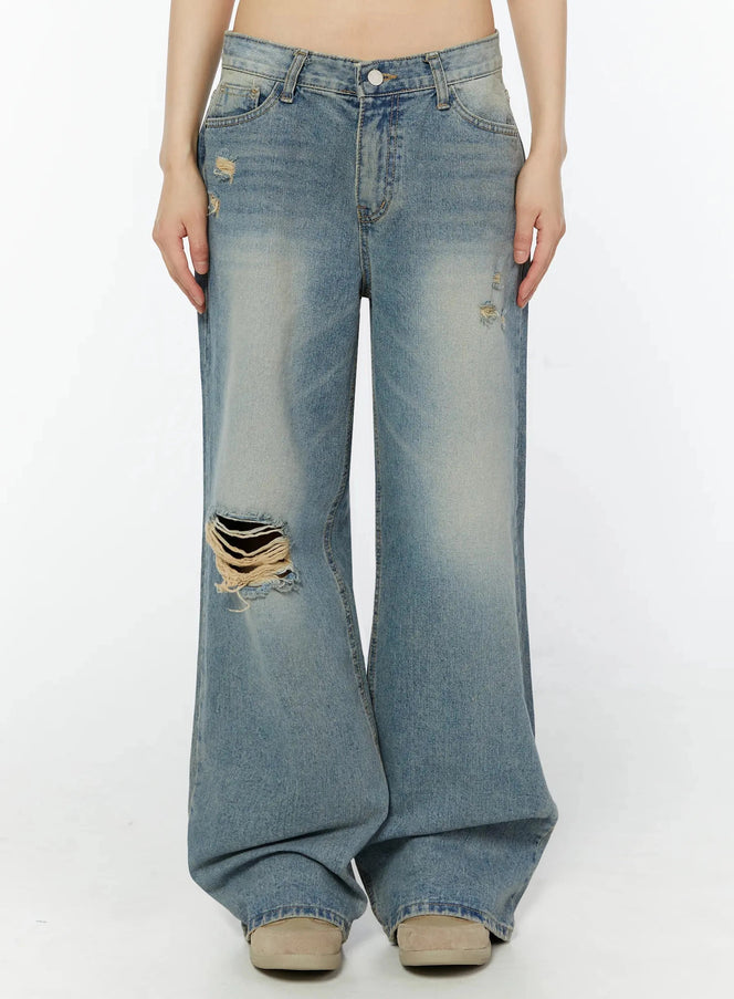 LEWKIN Colette Distressed Wide Leg Jeans IU518 in blue, front product shot on model, washed cotton straight fit with large knee rip and scattered distressing, pooling at hem.