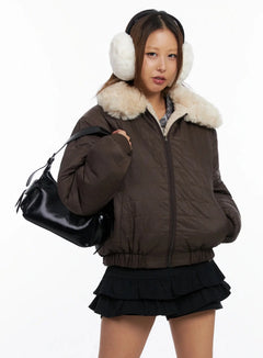 LEWKIN Reversible Quilted Bomber Jacket IN528 in brown, front three-quarter view on model, zipped up with cream sherpa collar, paired with black mini skirt and black bag, white earmuffs.