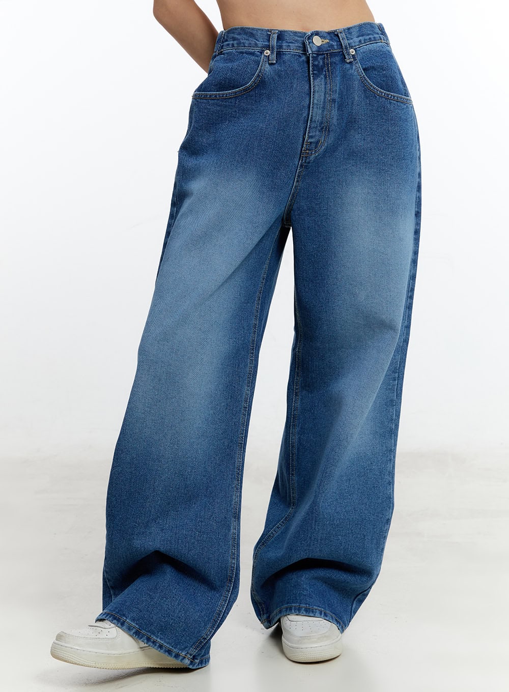 LEWKIN Eugene Adjustable Cinched-Back Wide-Leg Jeans CM521 in dark blue, front angled close-up on model, washed cotton denim, wide-leg silhouette with front pockets, paired with white sneakers.