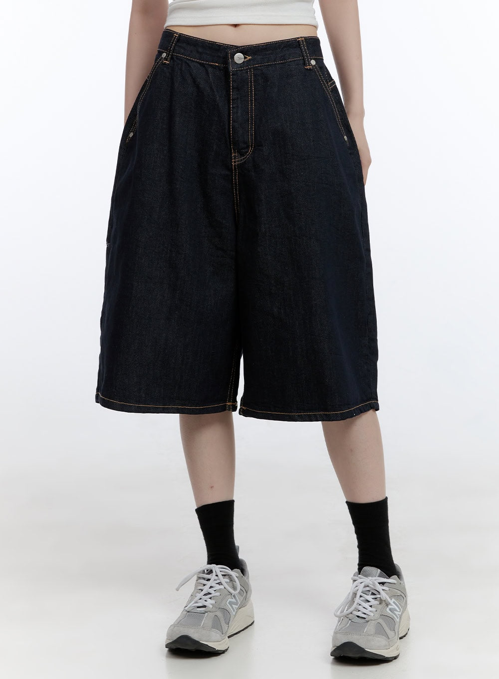 LEWKIN Dora Stitched Baggy Jorts CG413 in dark blue, front waist-down shot on model, wide-fit cotton denim with contrast topstitching, paired with white tee and grey sneakers.