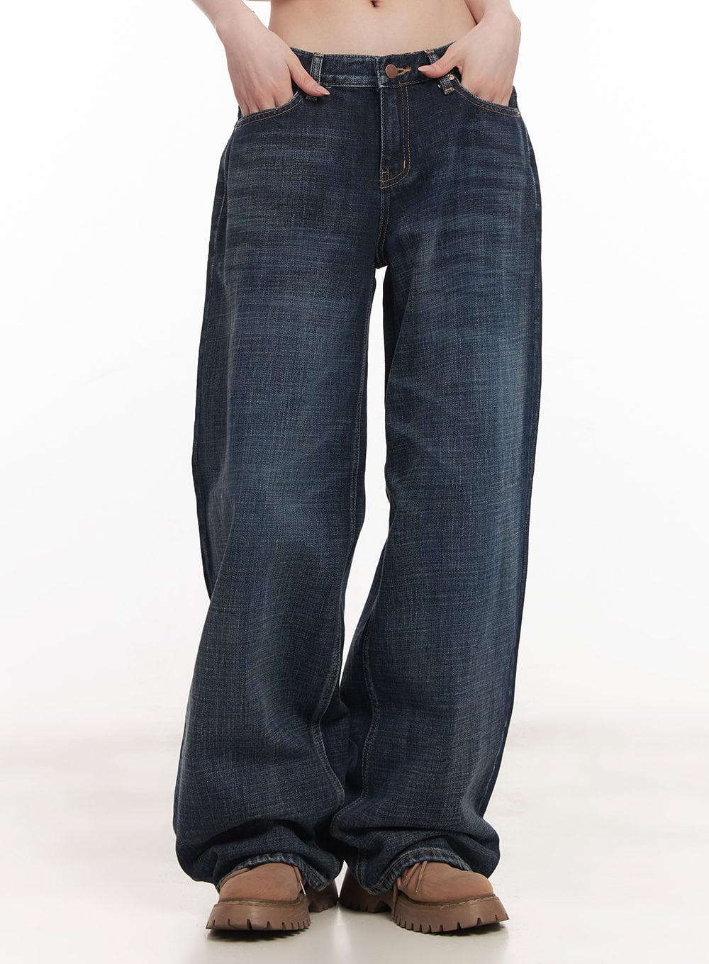 LEWKIN Annie Washed Wide-Leg Jeans CM518 in dark blue, front crop view on model, low-rise wide-fit washed cotton denim, hands in pockets, paired with brown chunky boots.