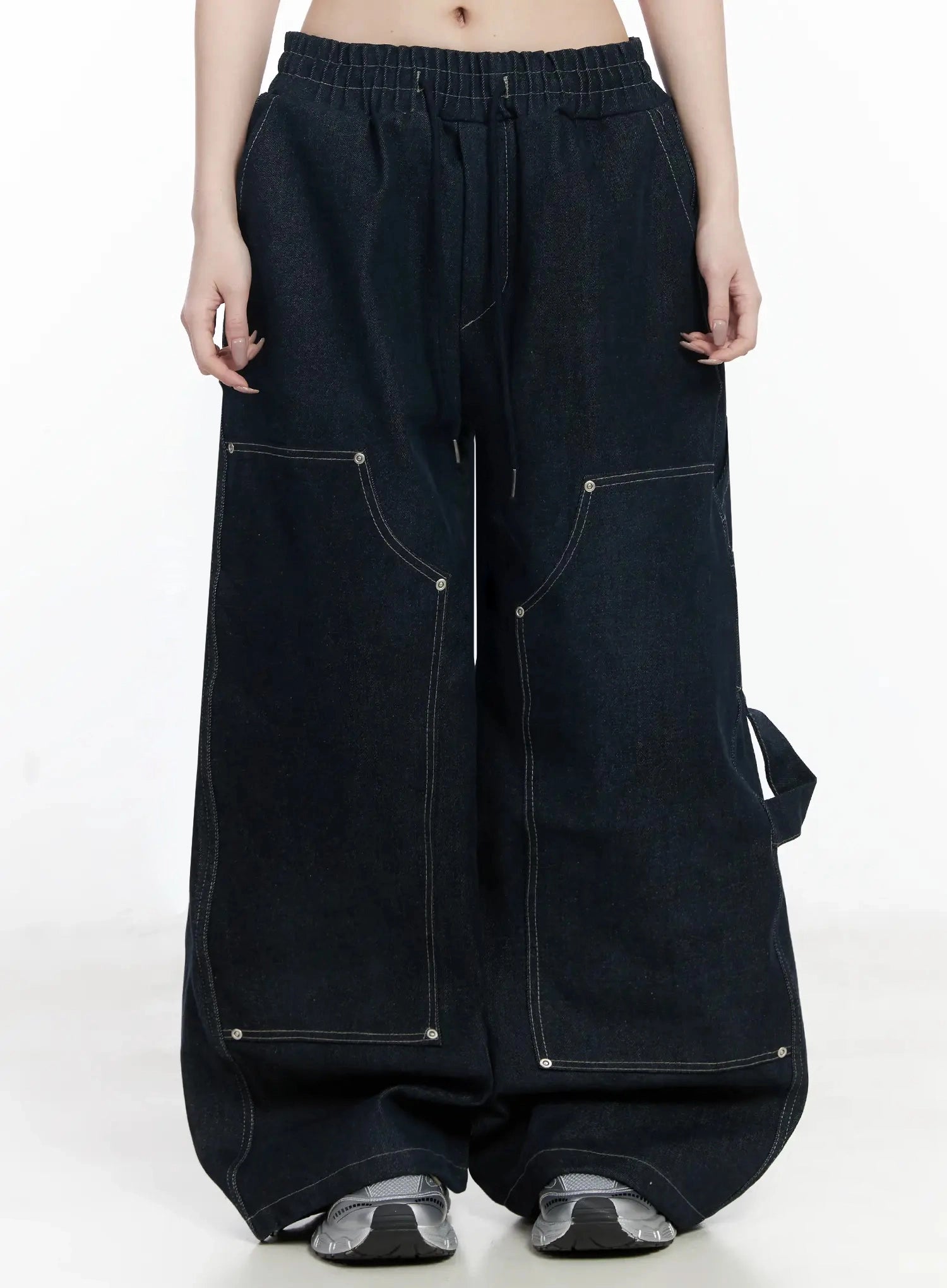 LEWKIN Ashlyn Carpenter Wide-Leg Jeans IJ528 in dark blue, front product shot on model, elastic drawstring waist, contrast white stitching, multi-pocket carpenter detail, extra-wide leg, sneakers.