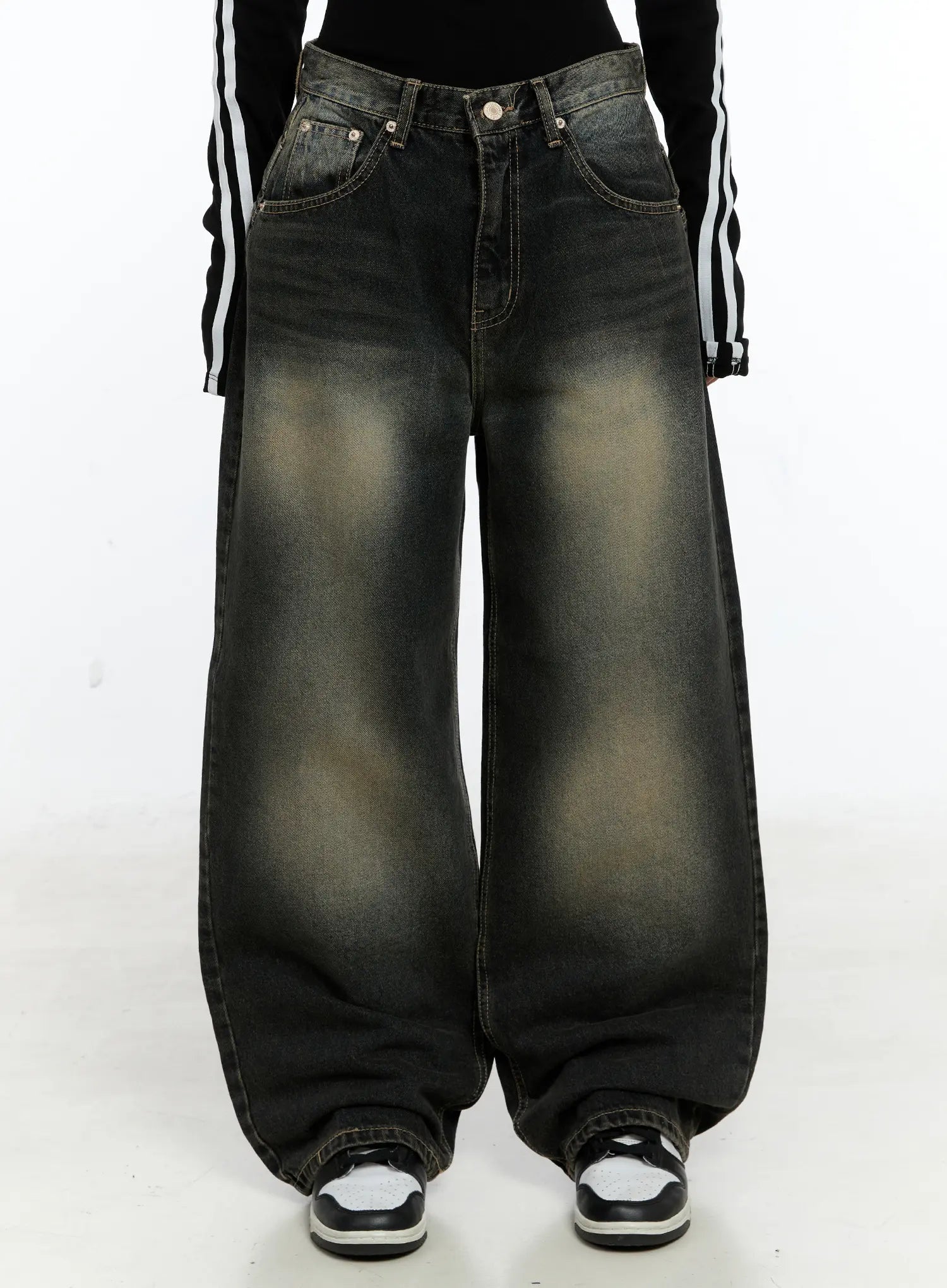 LEWKIN Emerie Washed Wide-Leg Baggy Jeans CS518 in dark blue, front crop view on model, ultra-wide baggy cotton denim with yellow-tinted wash fading, paired with black stripe top and sneakers.