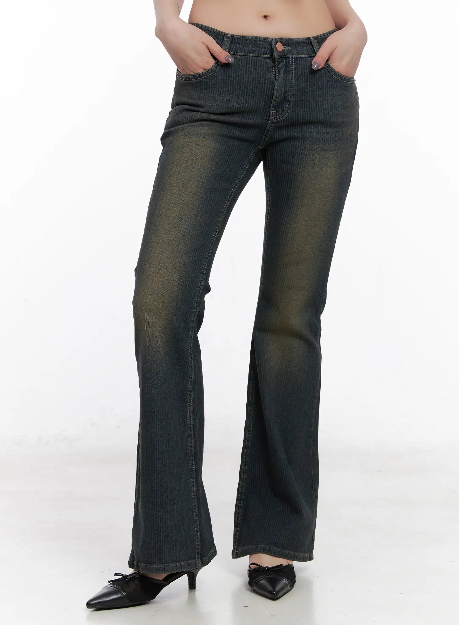 LEWKIN Soleil Hip Pad Stripe Hip Pad Flared Jeans CN512 in dark blue, front crop view on model, washed stripe cotton-spandex bootcut with low rise waist, hands in pockets, paired with black kitten-heel mules.