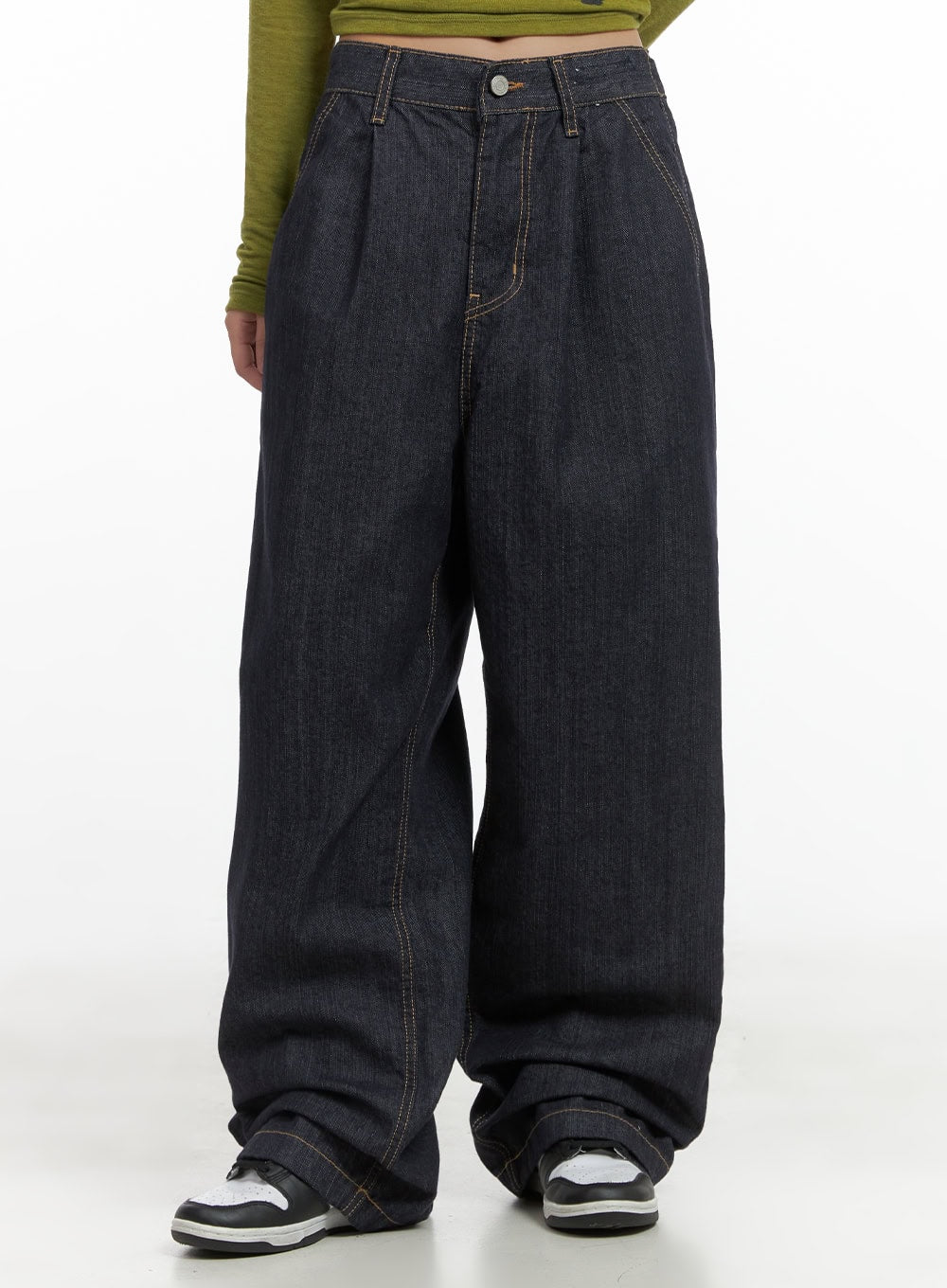 LEWKIN Lola Pintuck Baggy Jeans CO402 in dark blue, front cropped view on model, wide-fit cotton denim with pintuck pleats and contrast stitching, styled with olive graphic top and sneakers.