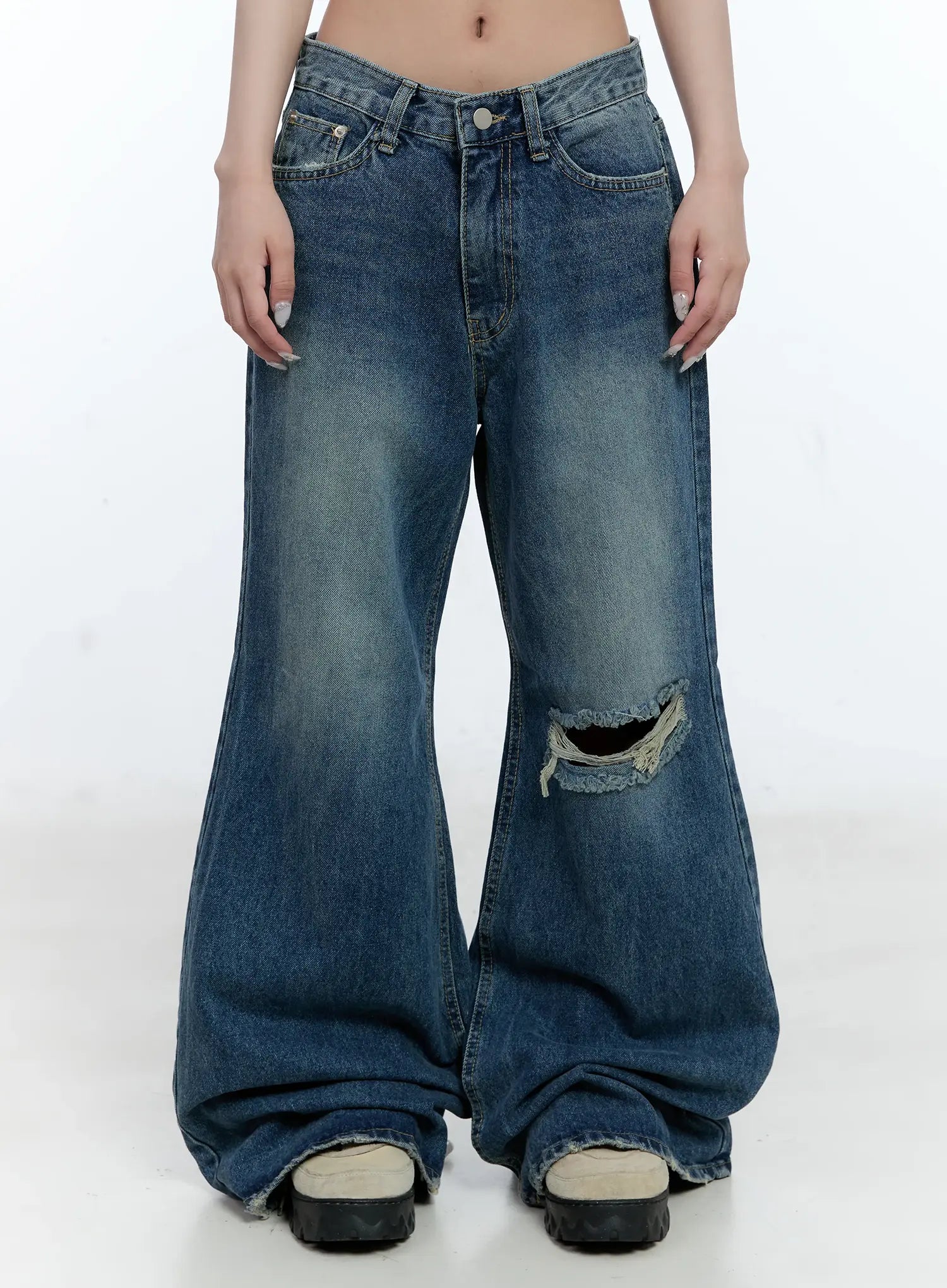 LEWKIN Gabi Distressed Semi-Flared Denim Jeans CG501 in dark blue, front view on model, wide-fit washed cotton with knee rip and semi-flared hem pooling over chunky sandals.