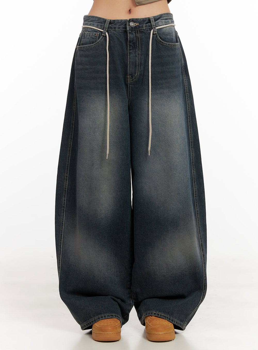 LEWKIN Vivian Washed Cotton Baggy Jeans CD409 in dark blue, front view on model cropped at waist, wide-fit washed denim with cream drawstring detail, paired with tan sneakers.