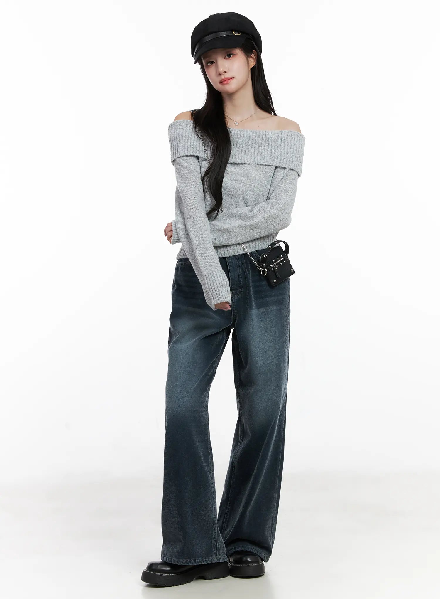 LEWKIN Zariah Baggy Jeans CN526 in dark blue, full-length front on model wearing gray off-shoulder knit, baker boy cap, and studded mini bag, wide leg washed cotton.