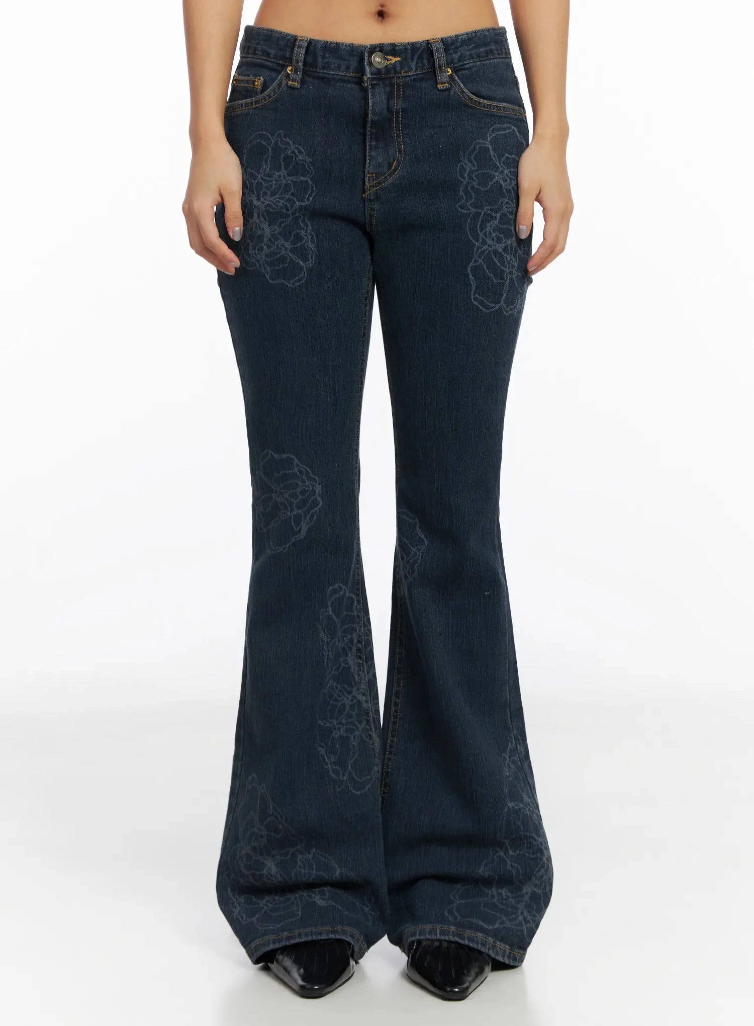 LEWKIN Amari Floral Embriodered Bootcut Jeans IN528 in dark blue, front full-length shot on model, floral outline stitch allover, low-rise bootcut flare, gold-tone hardware, worn with black patent boots.
