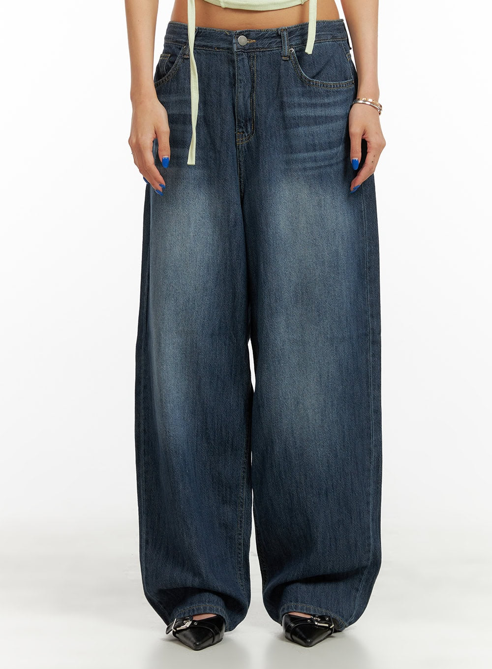 LEWKIN Low Rise Wide Fit Baggy Jeans CY431 in dark blue, front waist-down crop on model, washed cotton denim, low rise with wide baggy leg, styled with cream halter top and black mule heels.
