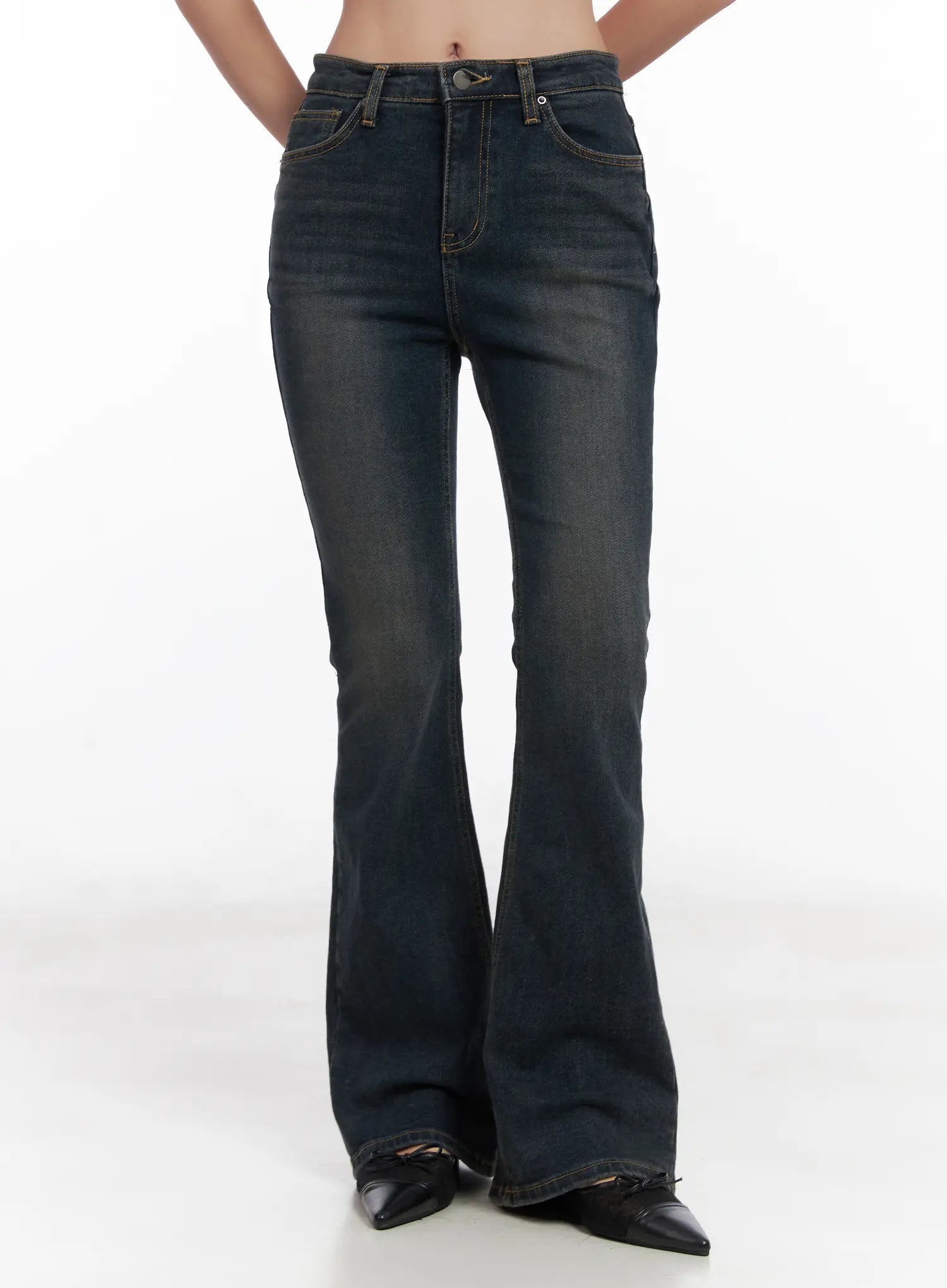 LEWKIN Jay Dark-Wash Bootcut Jeans CD501 in dark blue, front crop view on model, high-waist washed denim with flared bootcut leg, gold stitching, paired with black pointed heels.