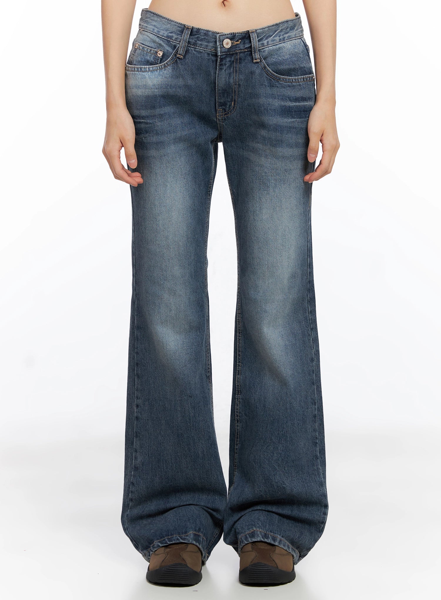 LEWKIN Myra Washed Bootcut Jeans IO516 in dark blue, front view on model, low-rise waist with button closure, washed cotton denim, bootcut flare leg, paired with brown chunky shoes.